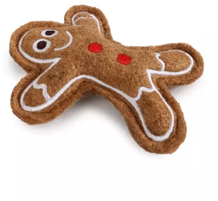 A brown felt gingerbread person dog toy with white icing-style outlines and small red accents, photographed on a plain white background.
