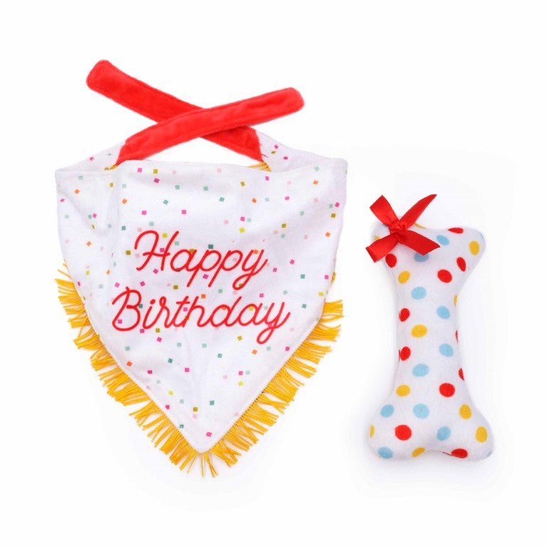 Birthday-themed baby bib and rattle set with colorful polka dots on a white background