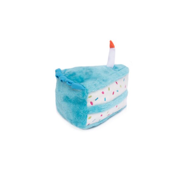 Plush toy shaped like a blue birthday cake with a white candle on a white background