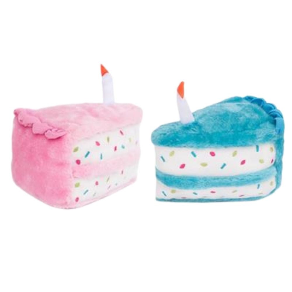 Two plush toys shaped like birthday cakes, one pink and one blue, on a white background.