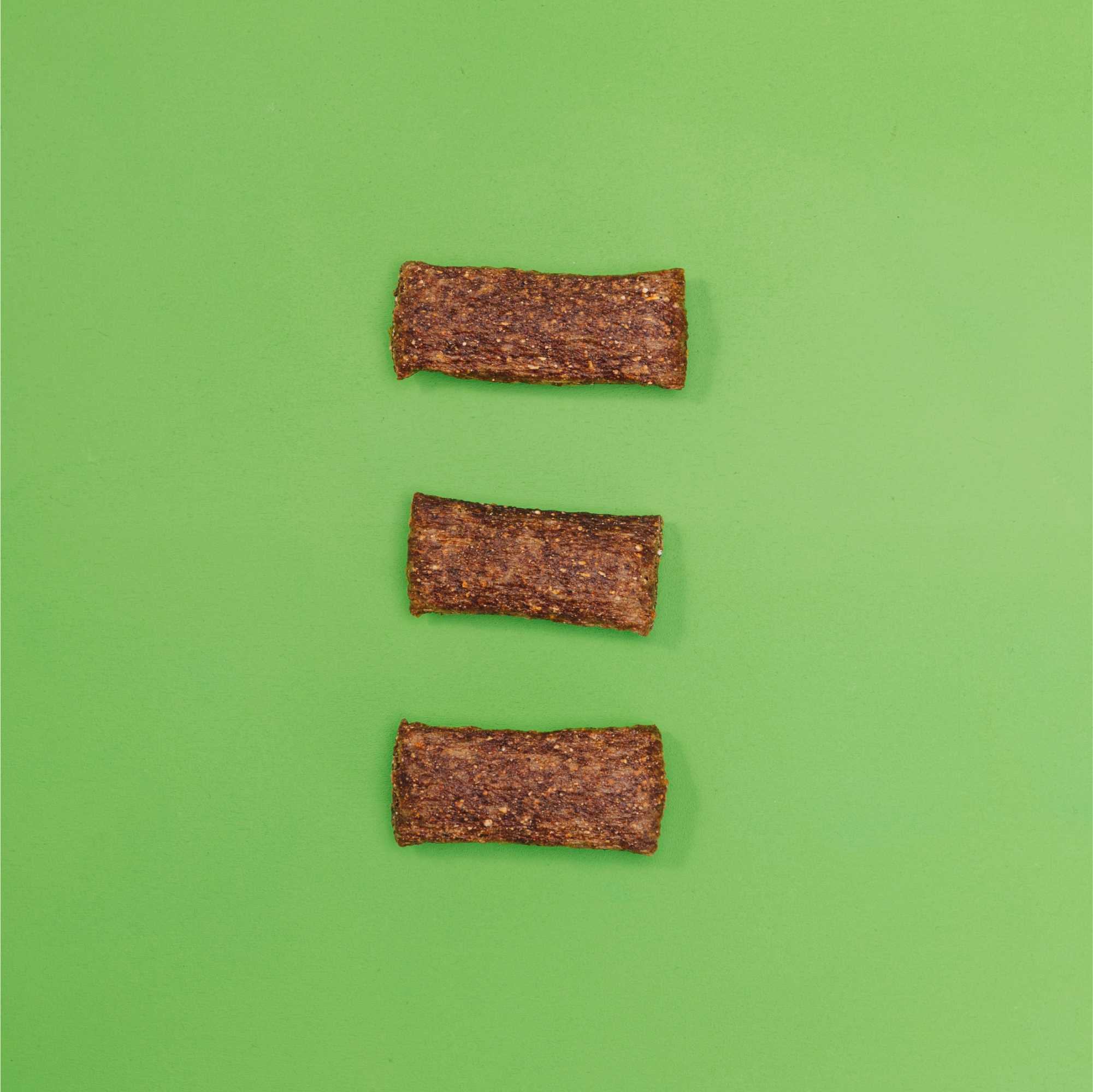 Three brown rectangular objects on a green background