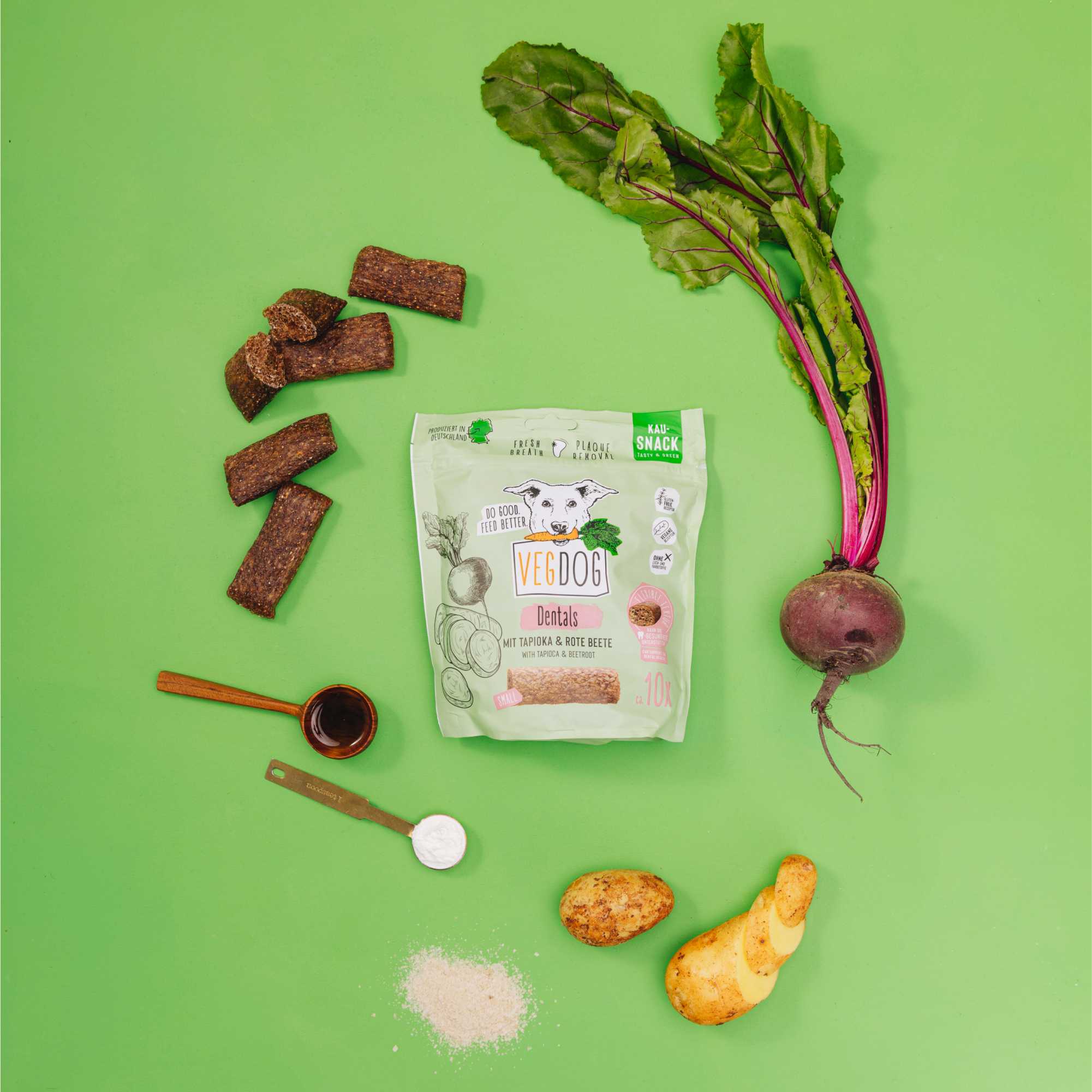 Dog food package with ingredients on a green background