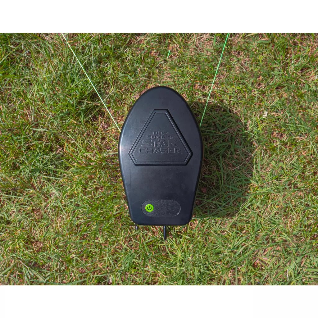 Black electronic device on grass with visible branding