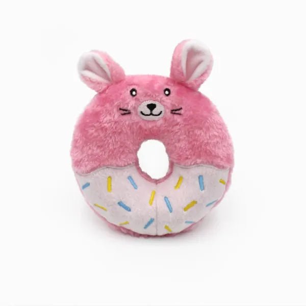 Pink donut-shaped plush toy with bunny ears on a white background