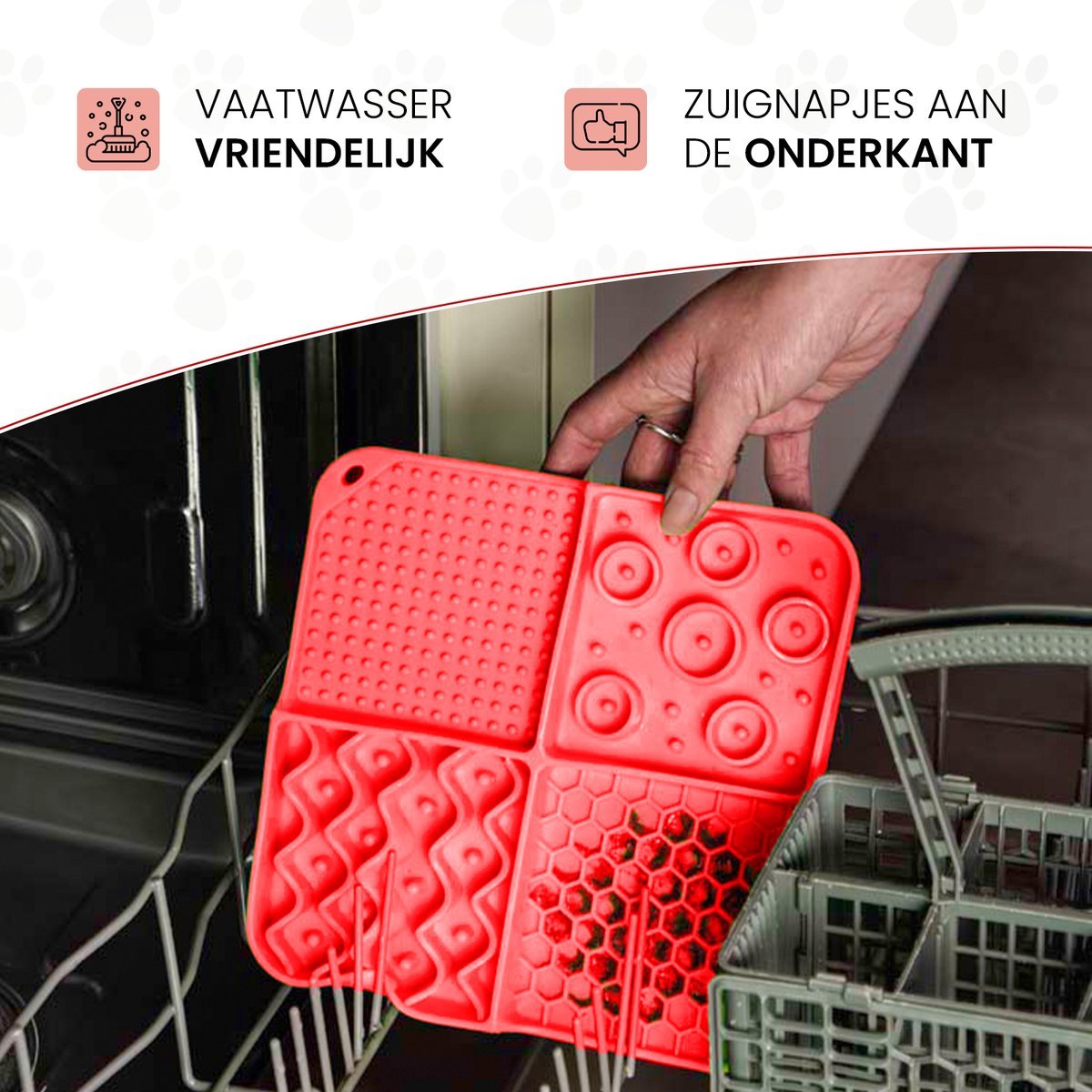 Red silicone mat with various shapes held by a hand above an open dishwasher.