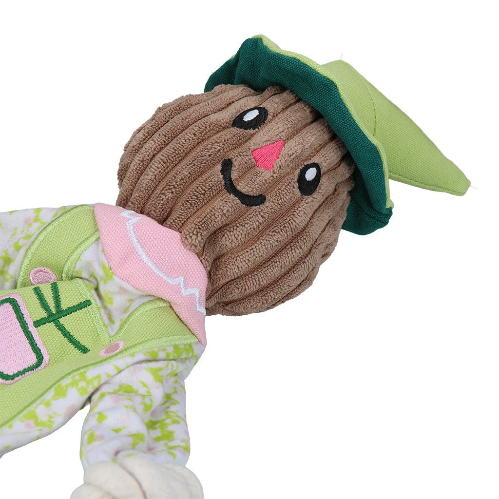 Plush toy with a smiling face, green hat, and pink cheeks on a white background