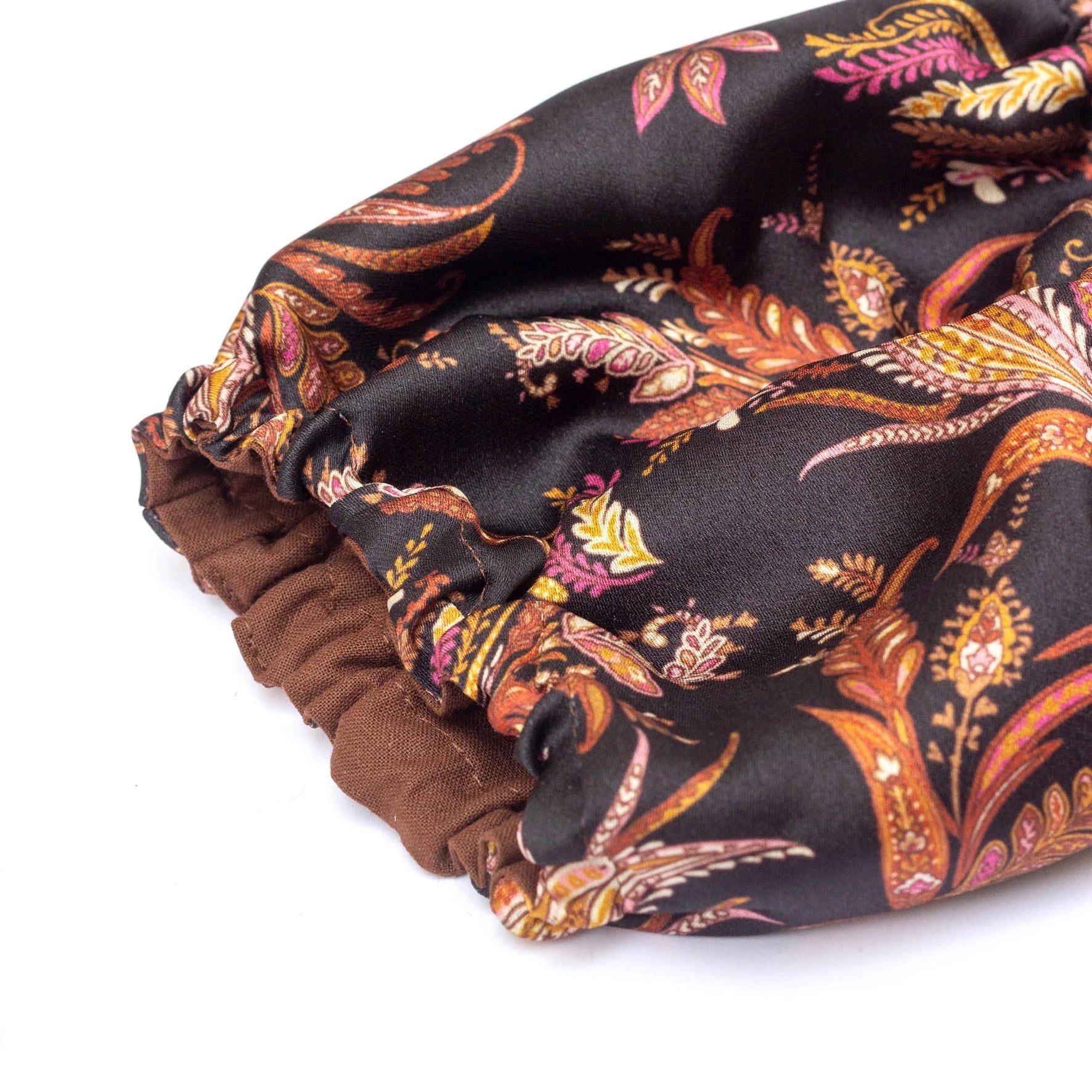 Floral-patterned fabric roll on a white background