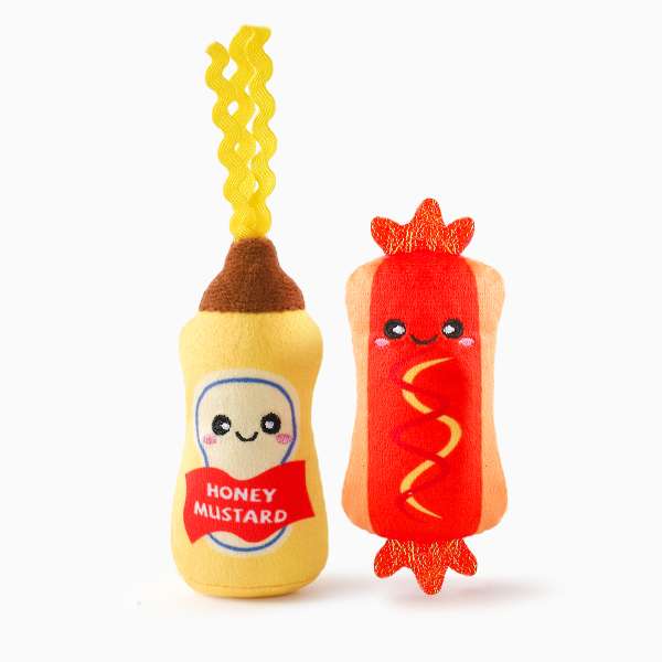 Plush toys resembling honey mustard and a hot dog on a white background