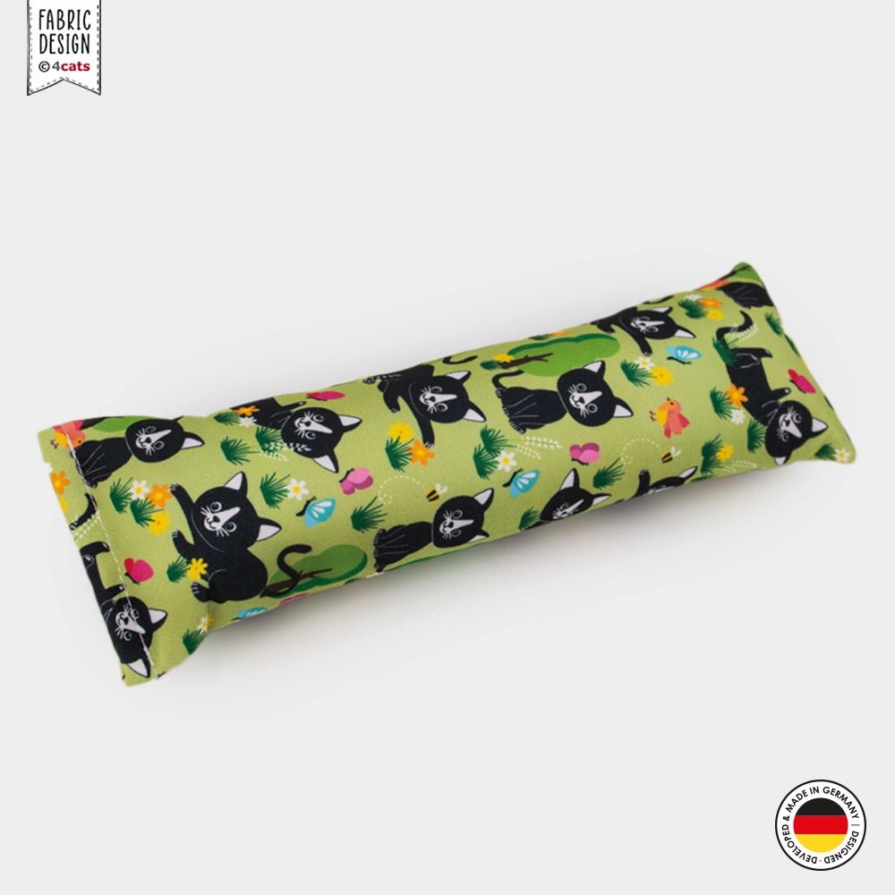 Long rectangular pillow with black cat pattern on a green background