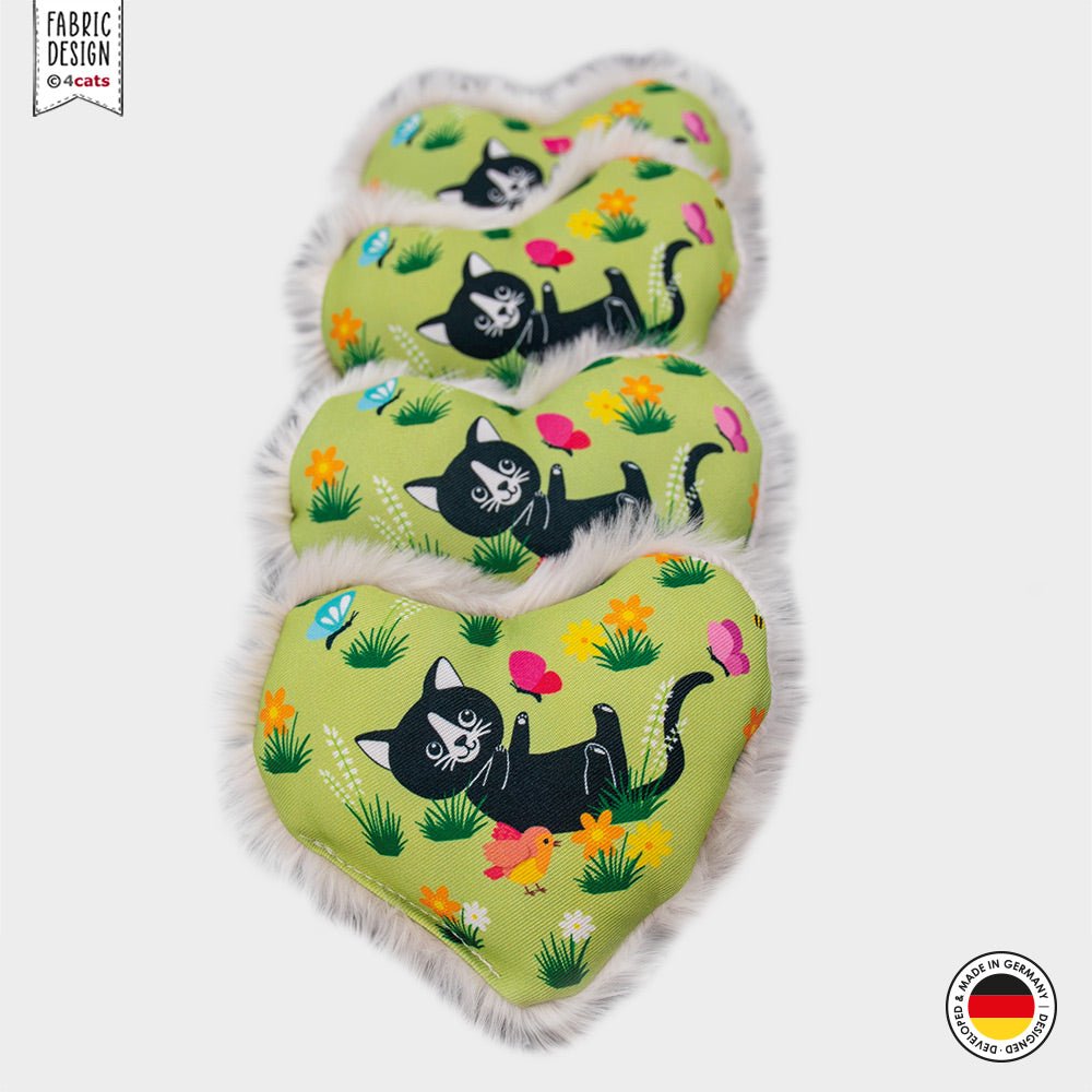 Heart-shaped catnip toy with black cat design on a green background, featuring the brand &