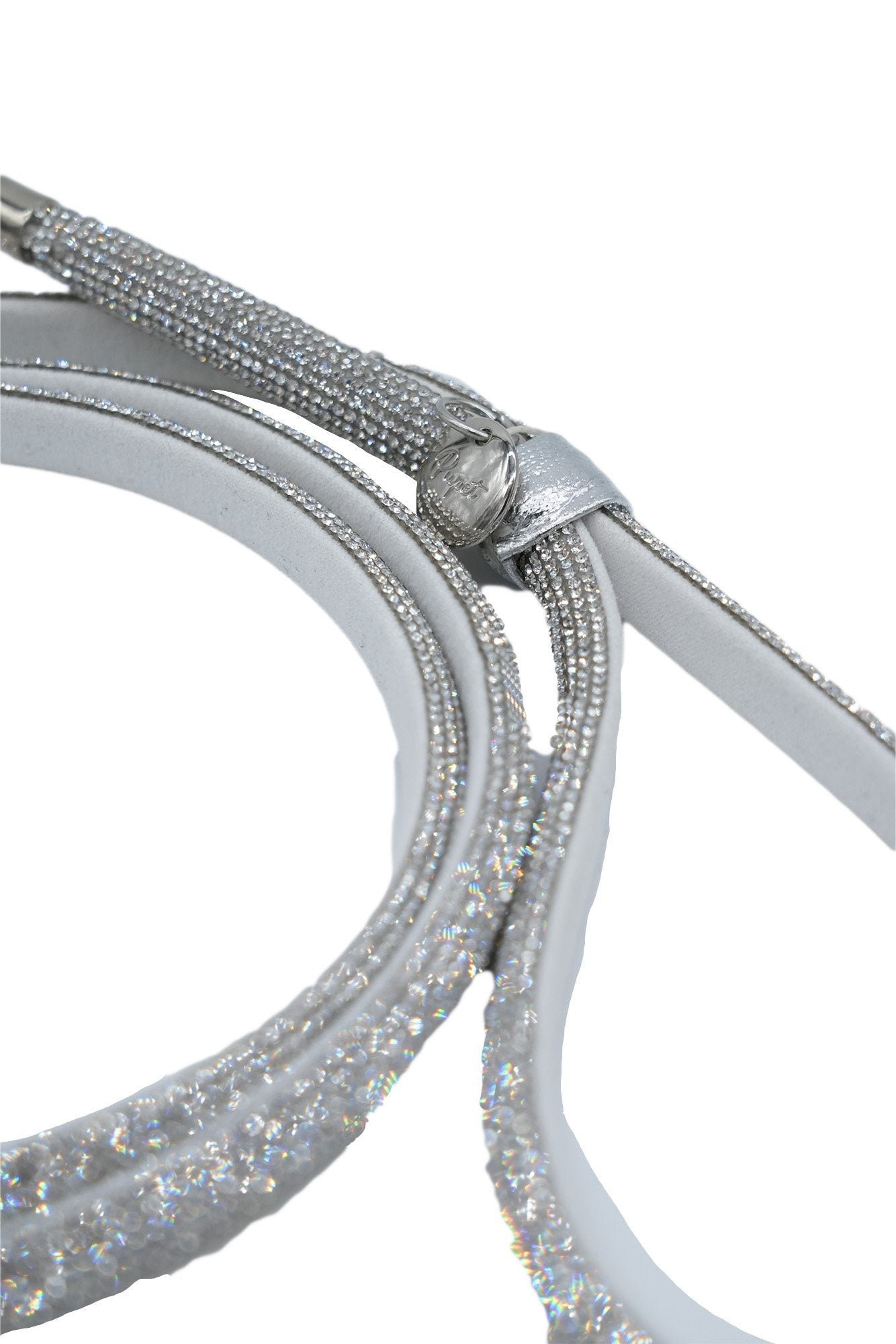 Close-up of a silver and glittery strap on a white background