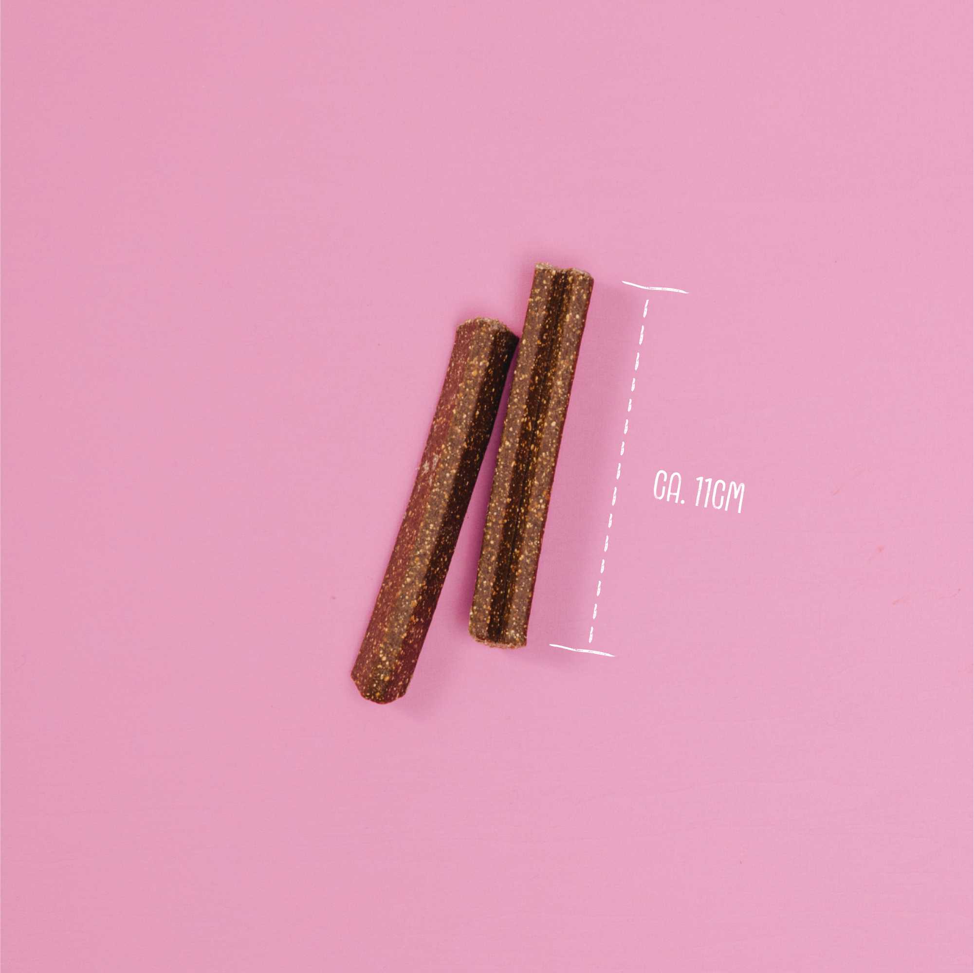 Two cylindrical objects on a pink background with a measurement label.