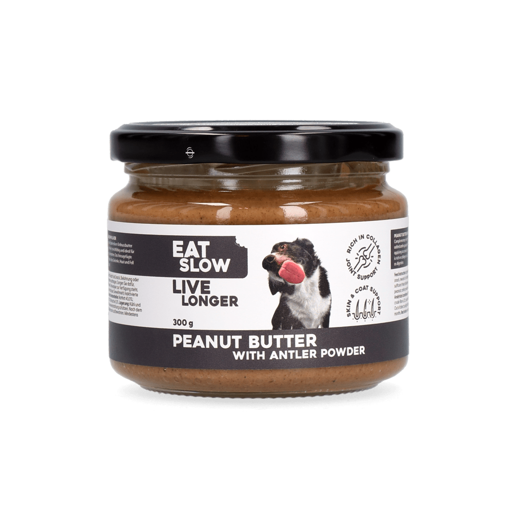 Jar of peanut butter with antler powder on a green background