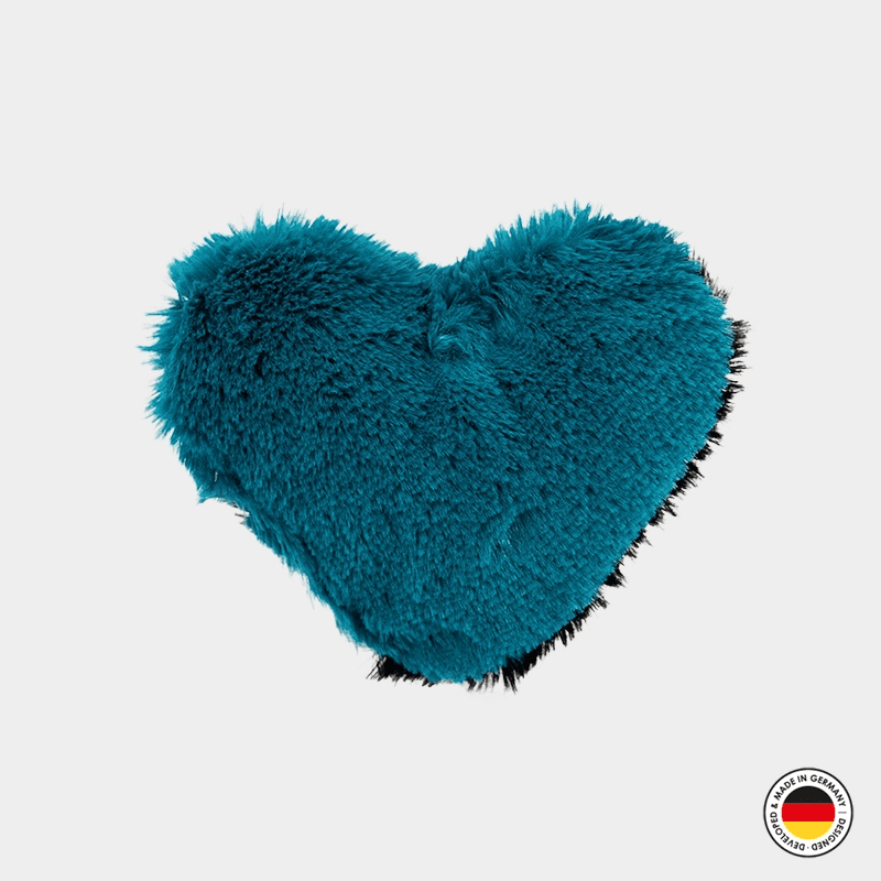 Teal heart-shaped pillow on a light gray background