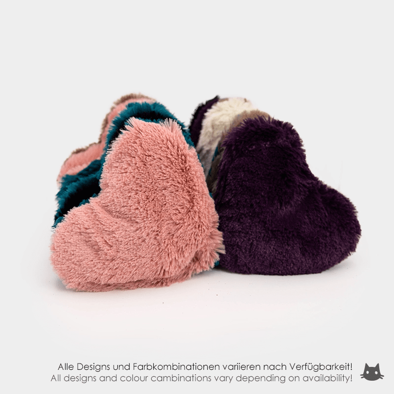 Two plush heart-shaped toys in pink and purple on a white background
