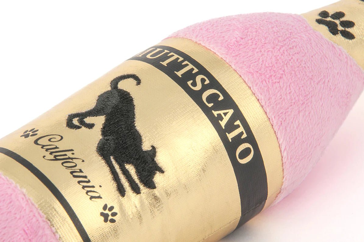 Pink yarn roll with gold label featuring a cat silhouette and text.