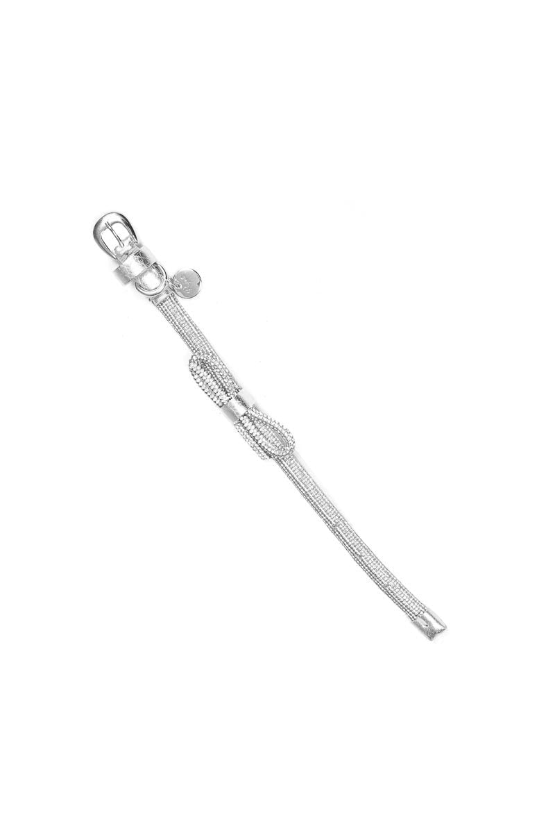 Silver bracelet with bow design on a white background