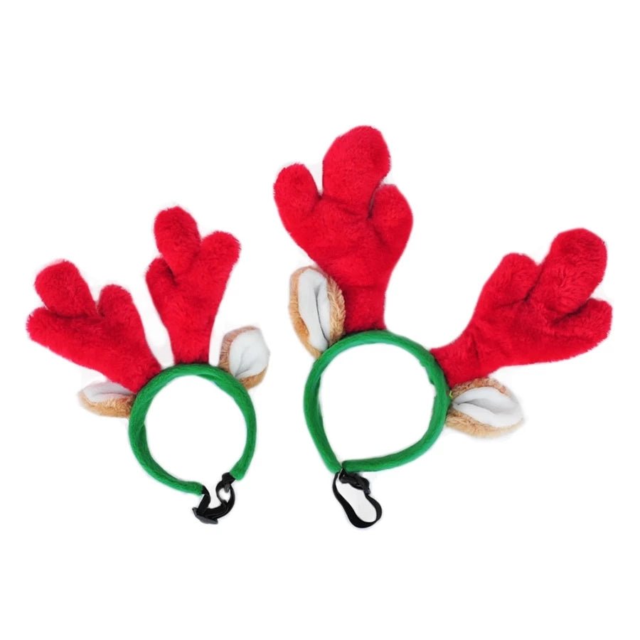 Red reindeer antlers with green headbands on a white background