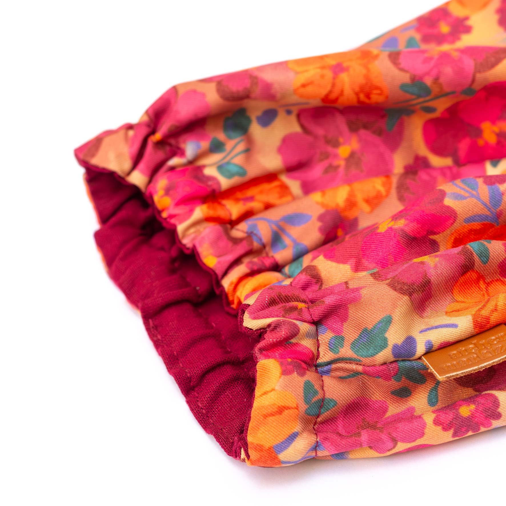 Folded colorful fabric with floral pattern on a white background