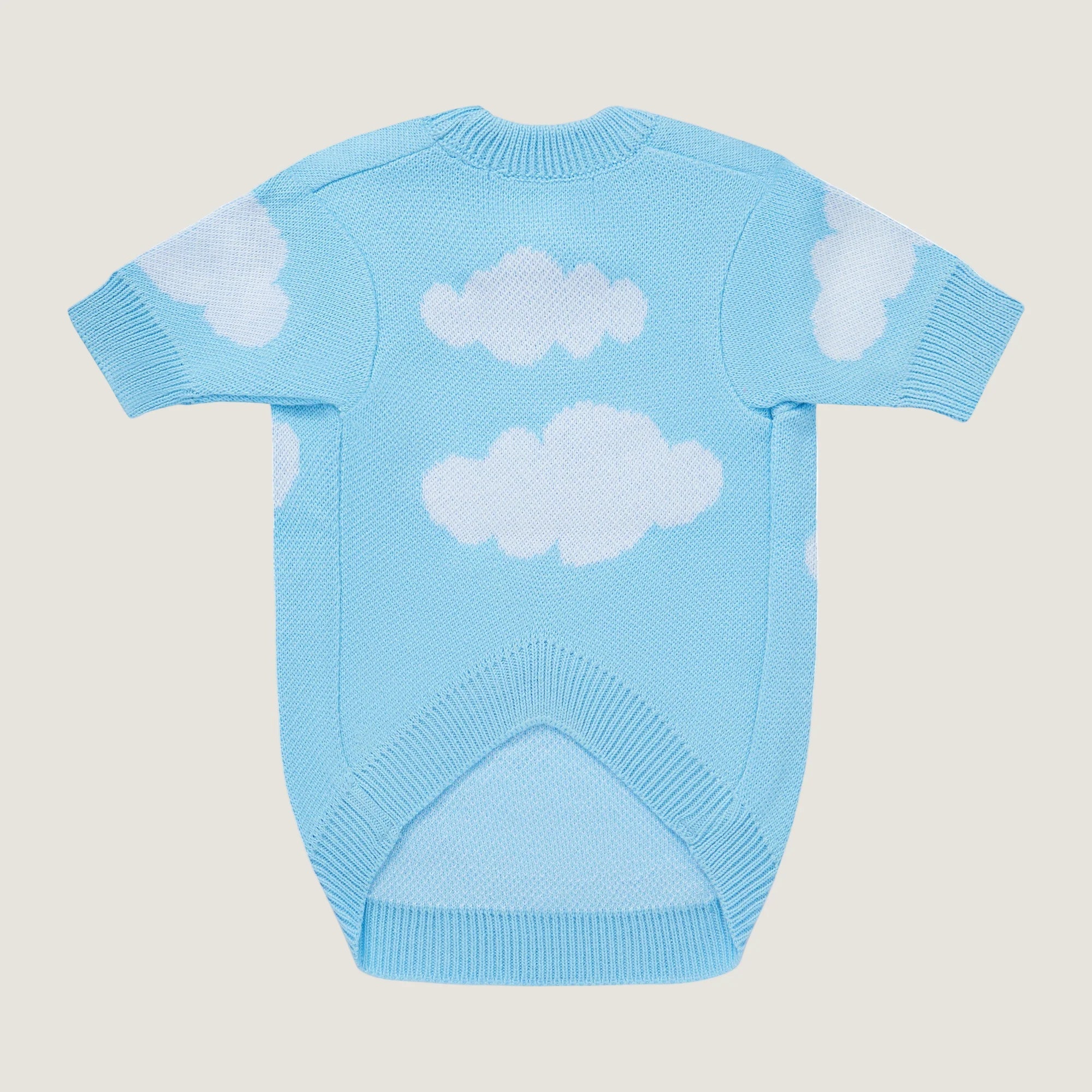 Light blue sweater with cloud patterns on a beige background