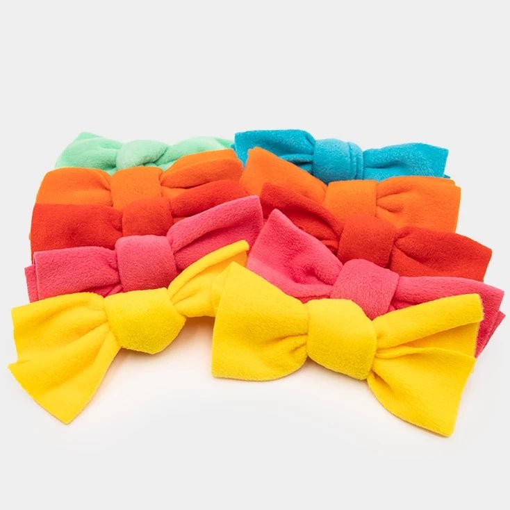 Colorful hair bows arranged on a white background