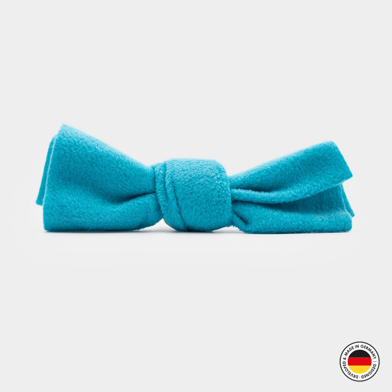 Turquoise bow tie on a light gray background