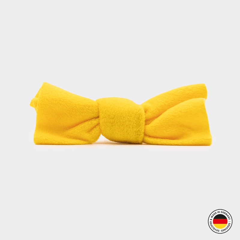 Yellow bow-shaped headband on a light gray background