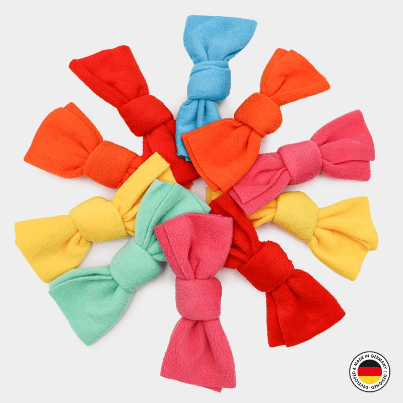 Colorful hair bows arranged in a circular pattern on a white background