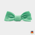 Mint green bow tie on a light gray background