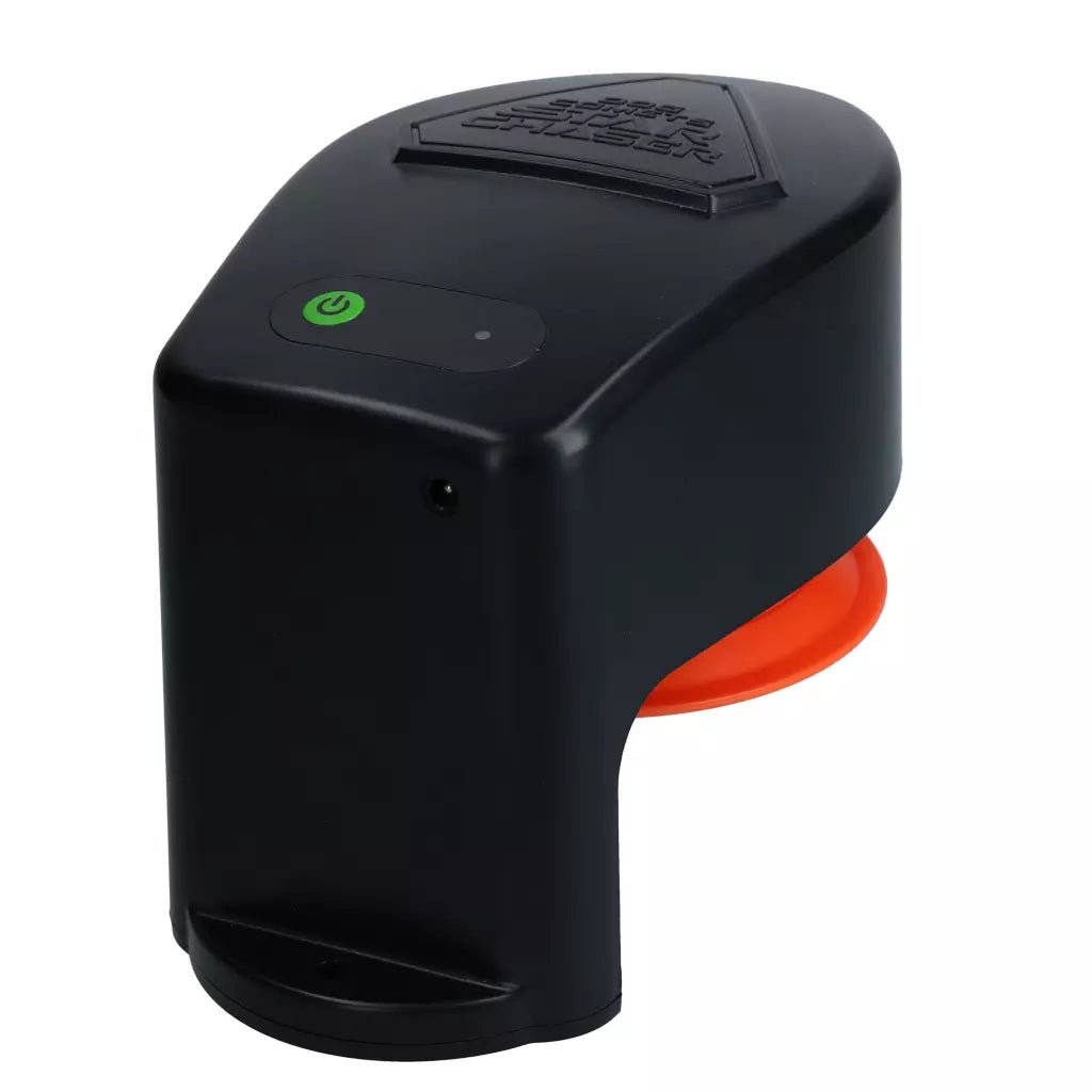 Black and orange electronic device with a green power indicator on a white background