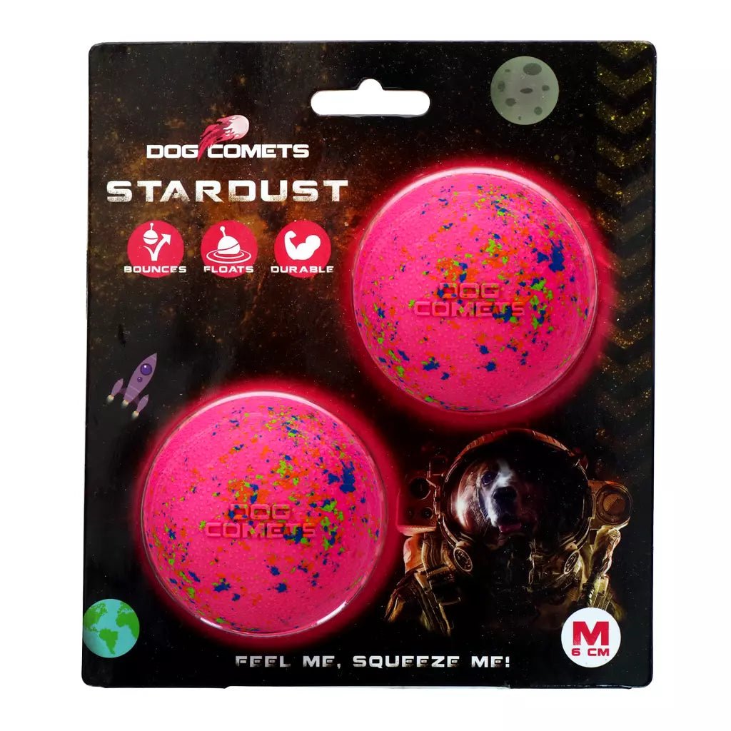 Pink dog toy balls with colorful specks in packaging, featuring &