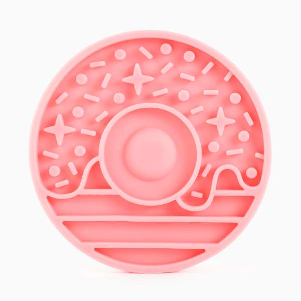 Pink donut-shaped object with star and circle patterns on a white background