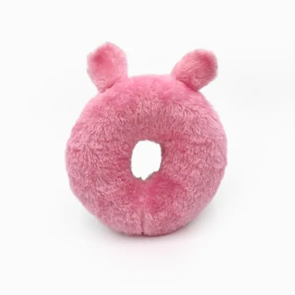 Pink plush donut toy with ears on a white background