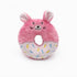 Pink donut-shaped plush toy with bunny ears on a white background