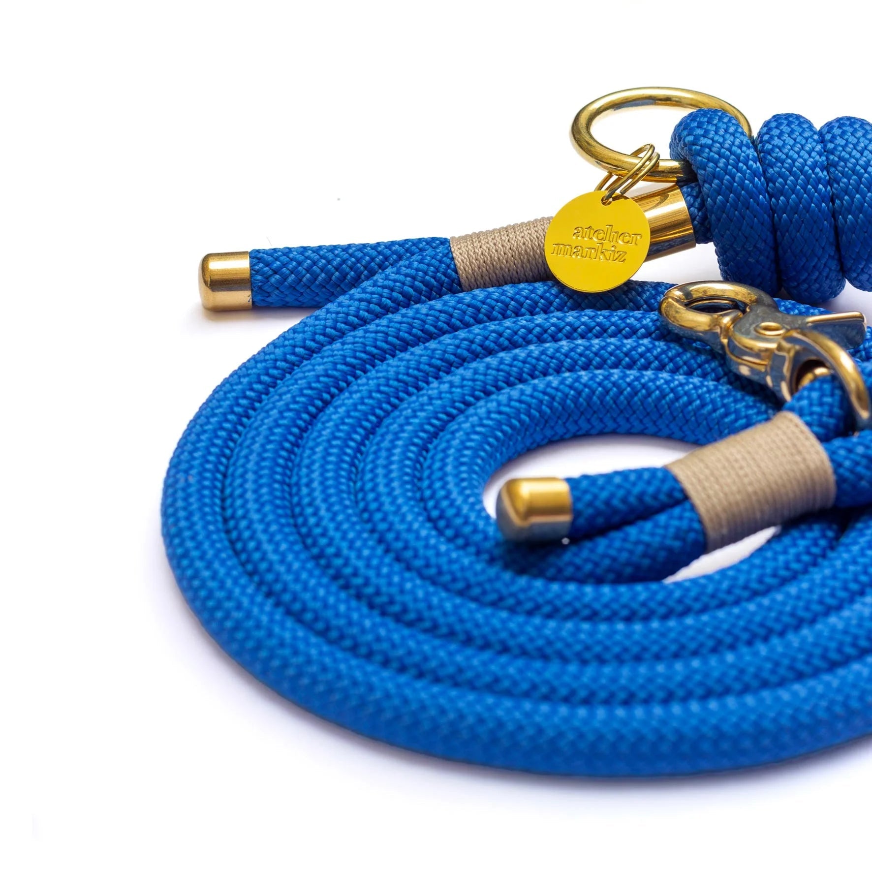Blue braided rope with gold hardware on a white background