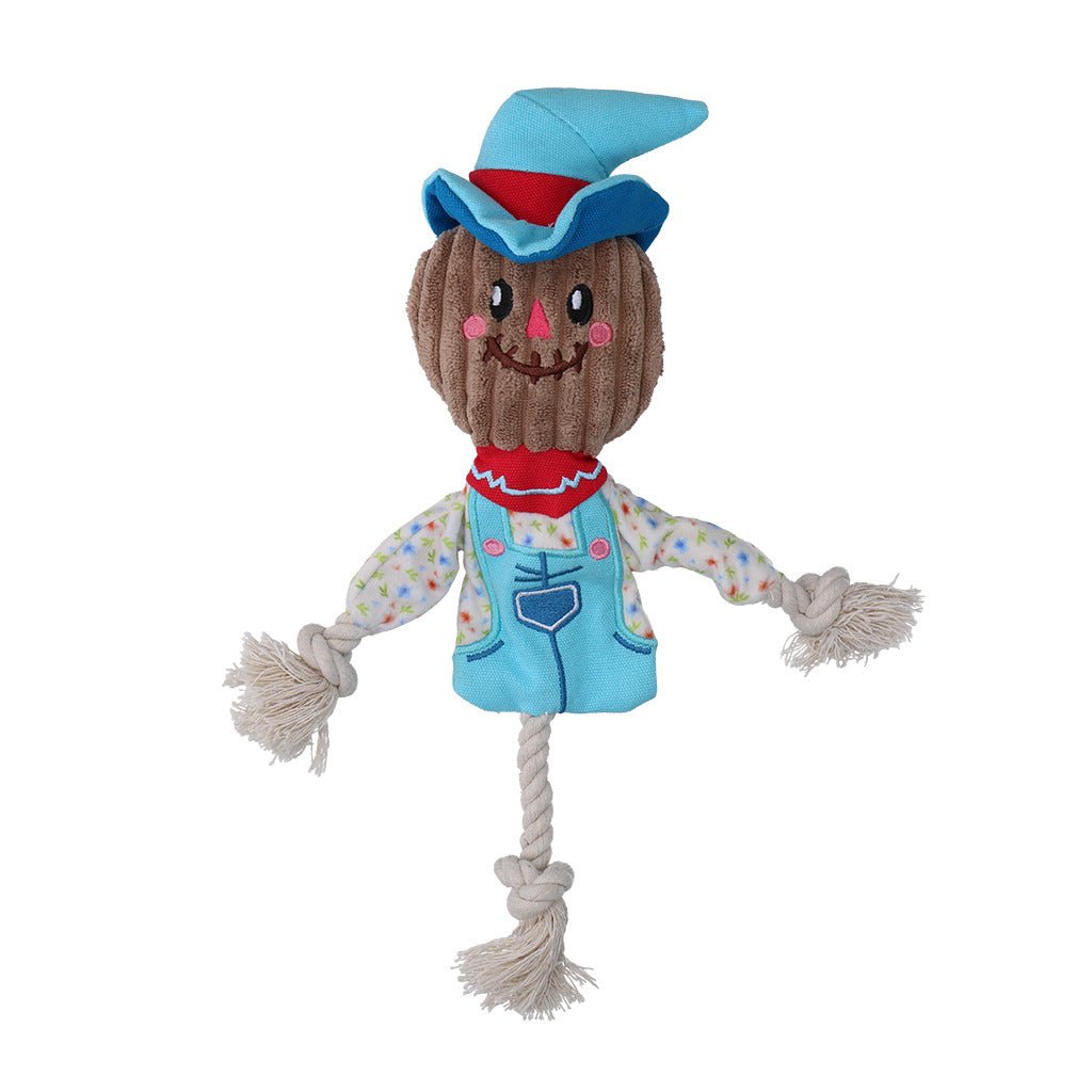 Plush scarecrow toy with a blue hat and overalls on a white background