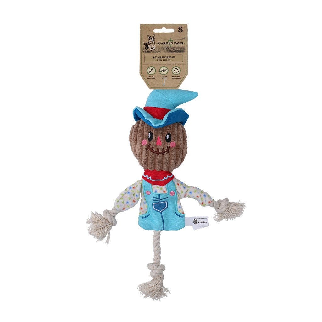 Scarecrow-shaped dog toy with a rope, featuring a packaging label on a white background.