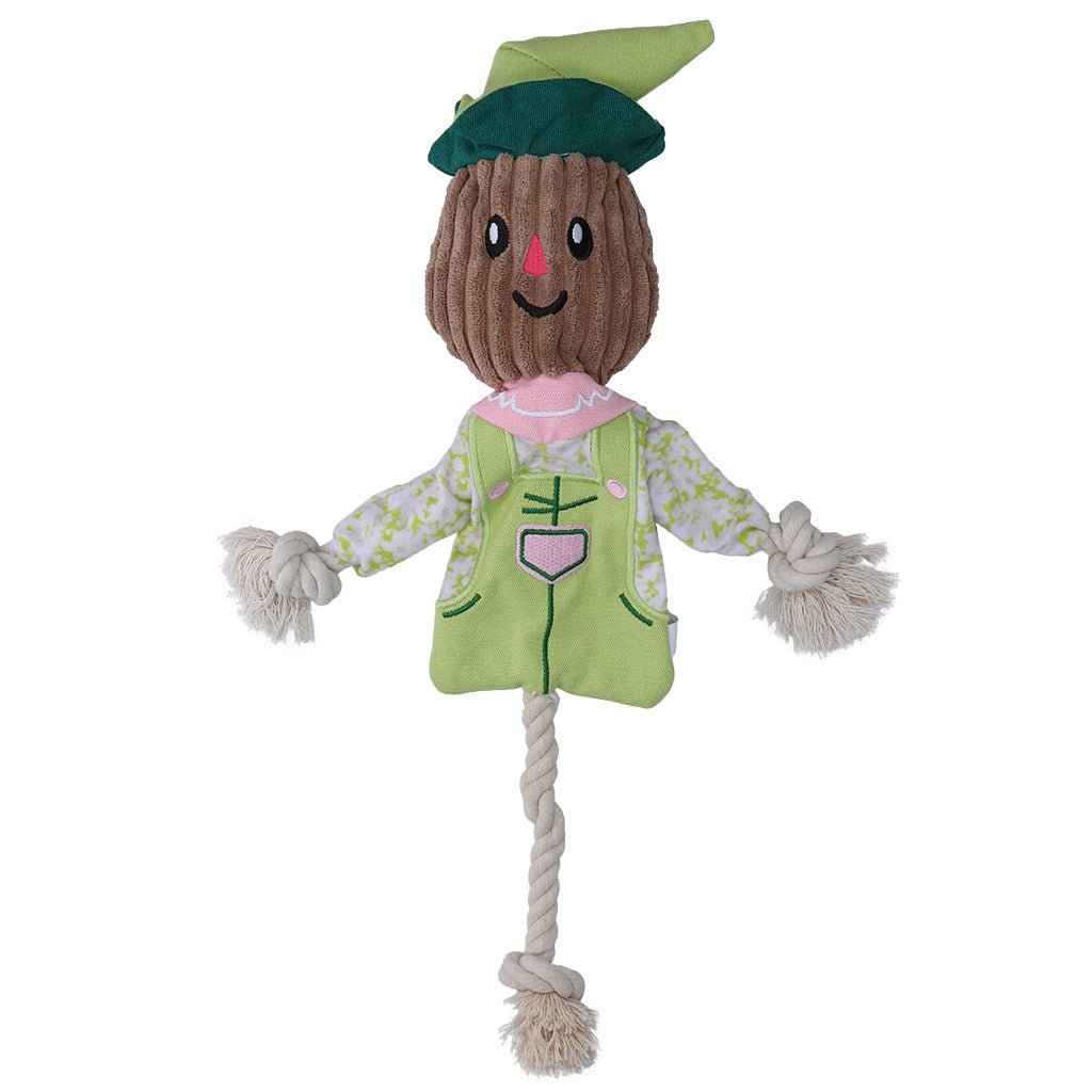Toy scarecrow with a green hat and outfit on a white background