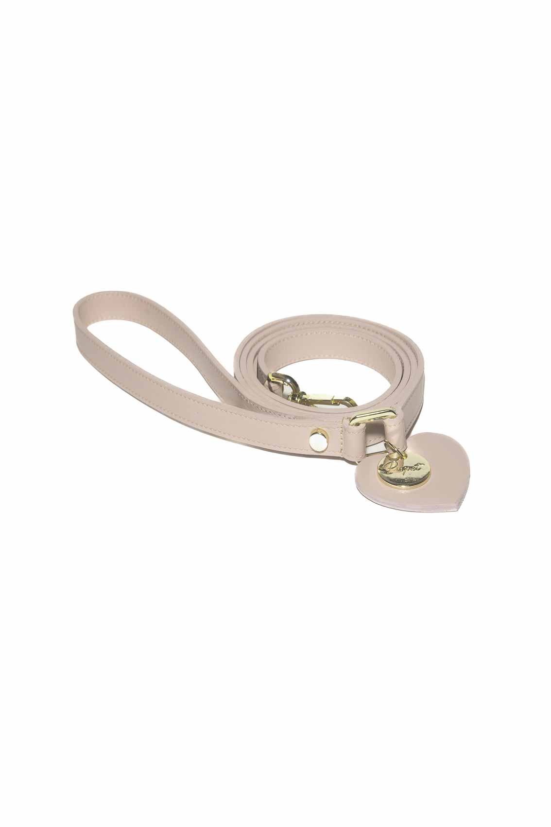 Beige dog leash with a heart-shaped tag on a white background