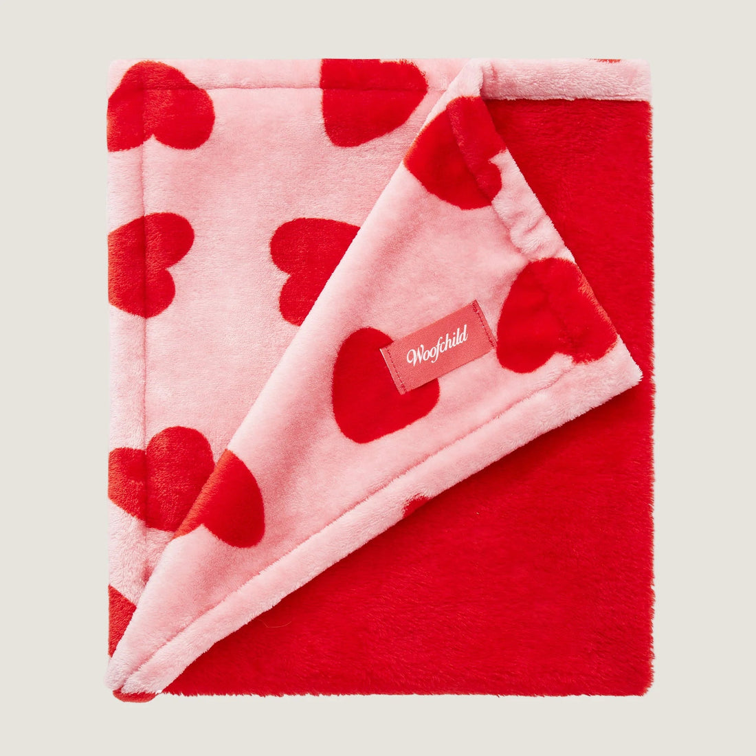Red and pink blanket with heart pattern and &