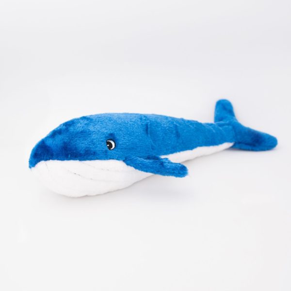 Blue and white plush whale toy on a light gray background