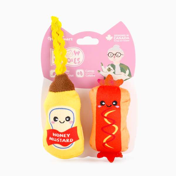 Two plush toys shaped like a mustard packet and a hot dog with mustard, on a white background.