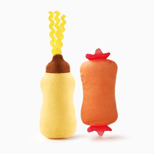 Plush toys resembling a bottle of mustard and a bottle of ketchup on a white background