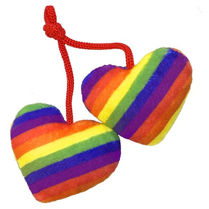 Two rainbow-striped heart-shaped toys on a red string against a white background