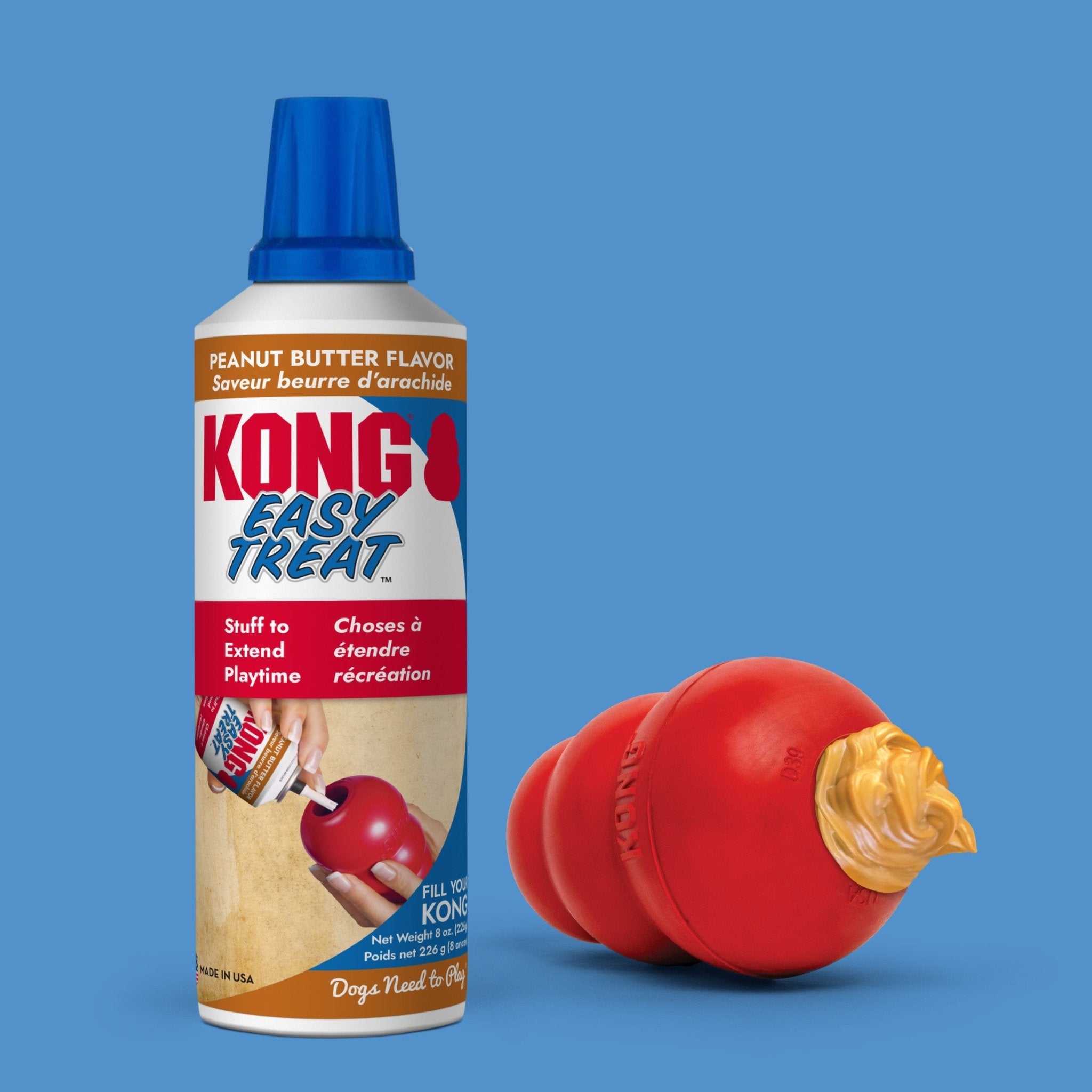 KONG Easy Treat can with a red dog toy filled with peanut butter on a blue background