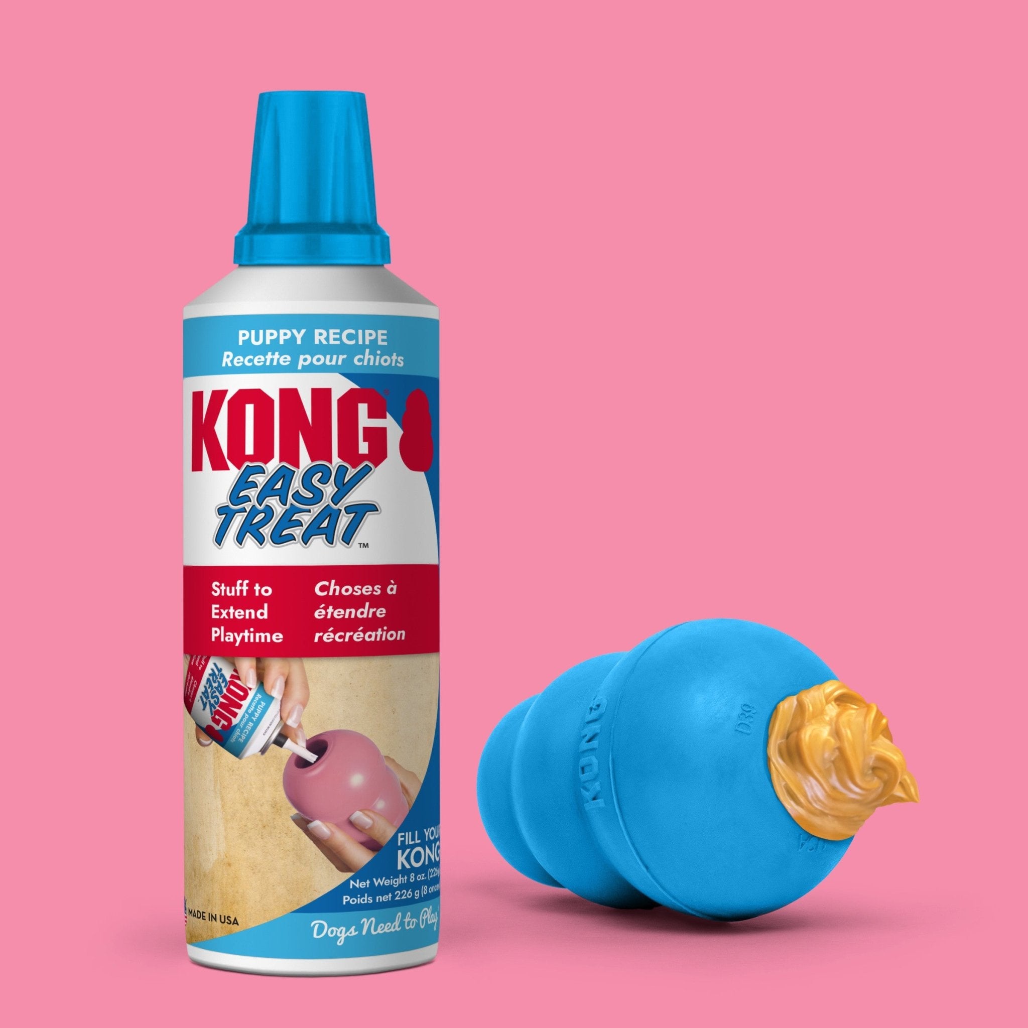 KONG Easy Treat can with a blue dog toy on a pink background
