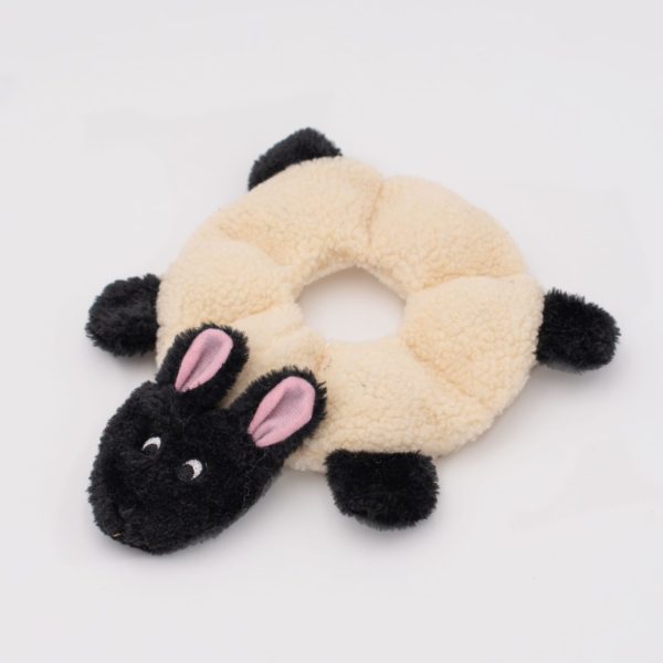 Plush sheep toy with black face and pink ears on a white background