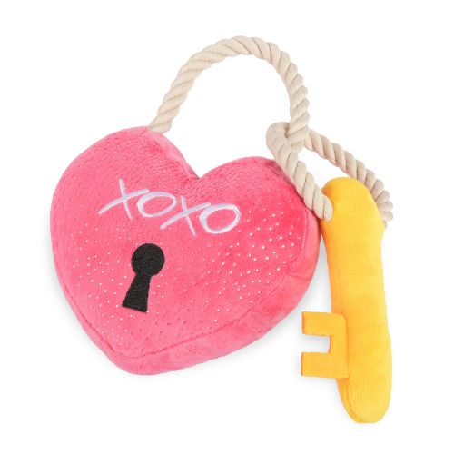Pink heart-shaped toy with a yellow key and rope on a white background