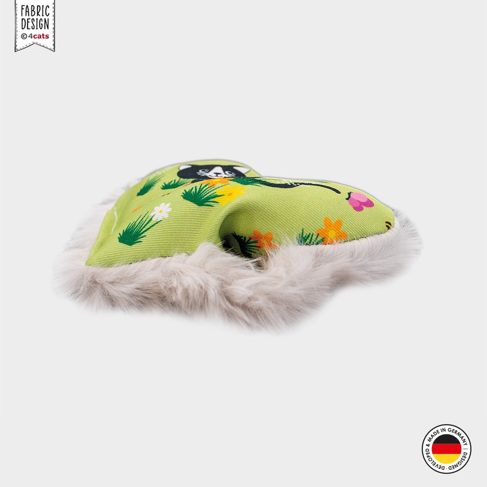 Green catnip toy with floral patterns on a white background