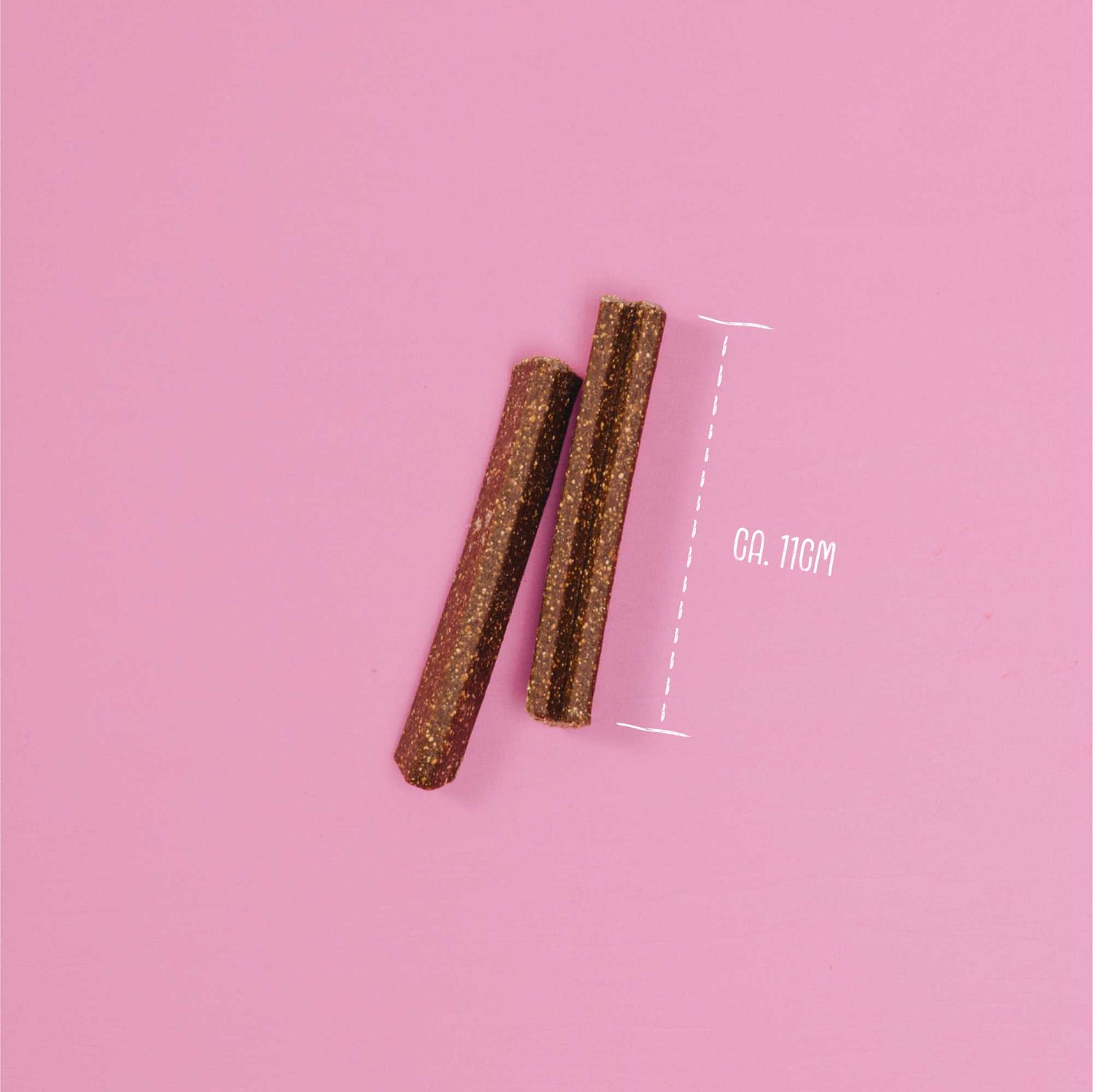 Two cylindrical objects on a pink background with a measurement label.